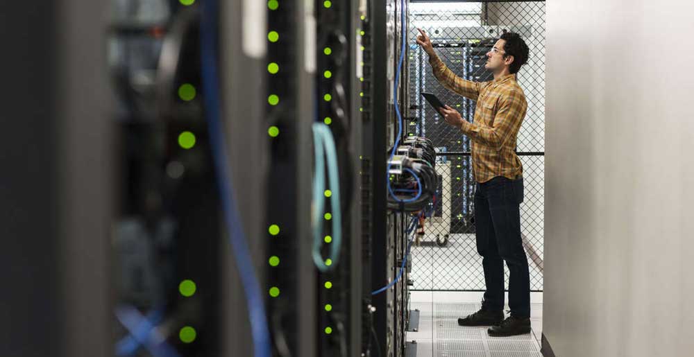 Technician working in computer server room